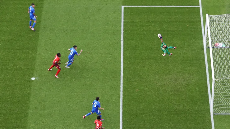 Image was captured using a remote camera positioned above the field of play) Gianluigi Donnarumma of Italy fails to save a shot from Ruben Vargas of Switzerland.