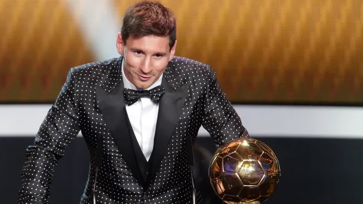 Lionel Messi of Argentina receives the FIFA Ballon d'Or 2012 trophy.