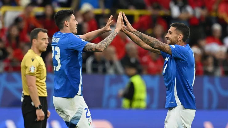 Alessandro Bastoni of Italy celebrates scoring his team's first goal with a header with teammate Lorenzo Pellegrini during the UEFA EURO 2024 group stage match between Italy and Albania.