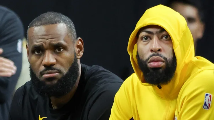 LeBron James (L) #23 and Anthony Davis #3 of the Los Angeles Lakers look on from the bench in the fourth quarter of their preseason game against the Brooklyn Nets at T-Mobile Arena on October 09, 2023 in Las Vegas, Nevada.