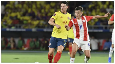 Andres Cubas of Paraguay and James Rodriguez of Colombia fight for the ball during a match