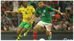 Daniel Johnson of Jamaica and Orbelin Pineda of Mexico fight for the ball during the match between Mexico and Jamaica