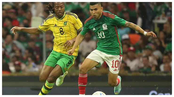 Daniel Johnson of Jamaica and Orbelin Pineda of Mexico fight for the ball during the match between Mexico and Jamaica