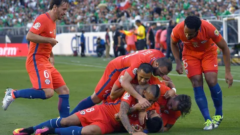 Edson Puch of Chile is piled on by teammates after he scored a goal against Mexico during the 2016 Copa America Quarterfinals