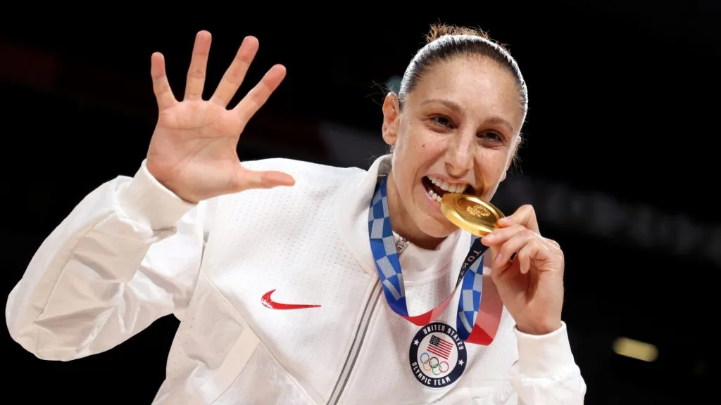 Diana Taurasi #12 of Team United States bites her gold medal during the Women's Basketball medal ceremony on day sixteen of the 2020 Tokyo Olympic games at Saitama Super Arena on August 08, 2021 in Saitama, Japan.