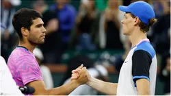 Carlos Alcaraz of Spain shakes hands with Jannik Sinner of Italy.