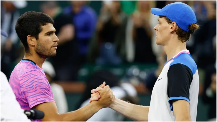 Carlos Alcaraz of Spain shakes hands with Jannik Sinner of Italy.