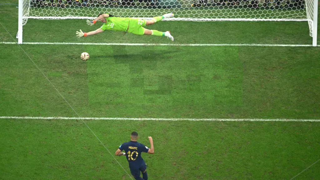 Kylian Mbappe of France scores the team's first goal from the penalty spot past Emiliano Martinez of Argentina during the FIFA World Cup Qatar 2022 Final match between Argentina and France at Lusail Stadium on December 18, 2022 in Lusail City, Qatar.