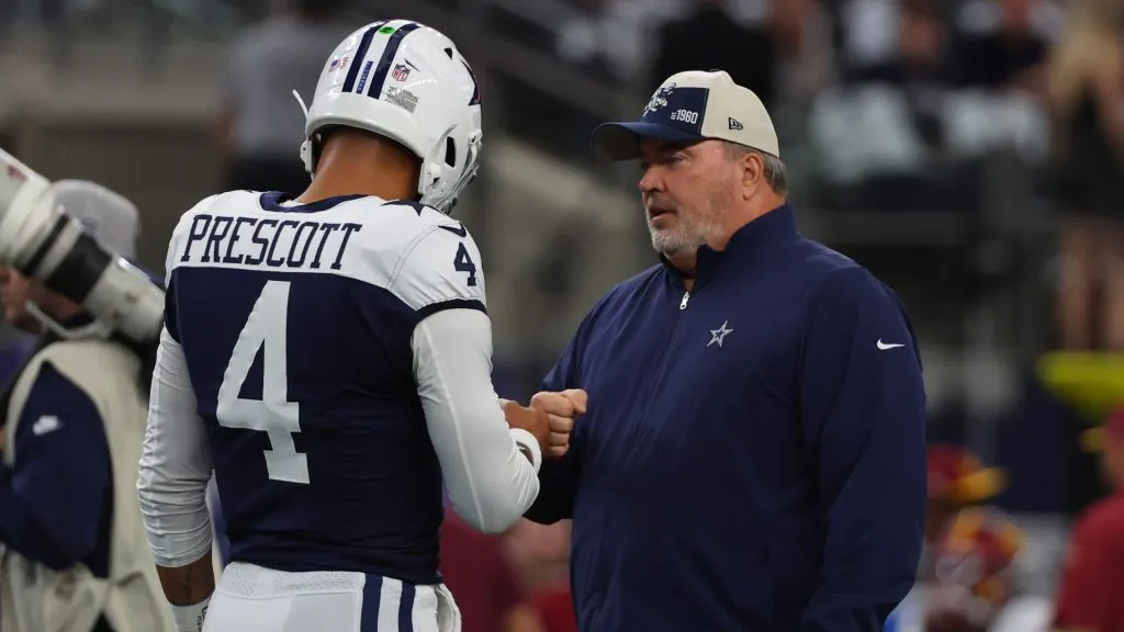 Head coach Mike McCarthy of the Dallas Cowboys interacts with Dak Prescott #4 of the Dallas Cowboys prior to the game against the Washington Commanders at AT&amp;T Stadium on November 23, 2023 in Arlington, Texas.
