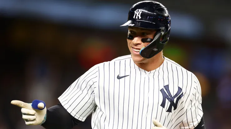 Aaron Judge #99 of the New York Yankees points to the dugout after hitting his third home run of the game against the Washington Nationals at Yankee Stadium on August 23, 2023 in the Bronx borough of New York City.