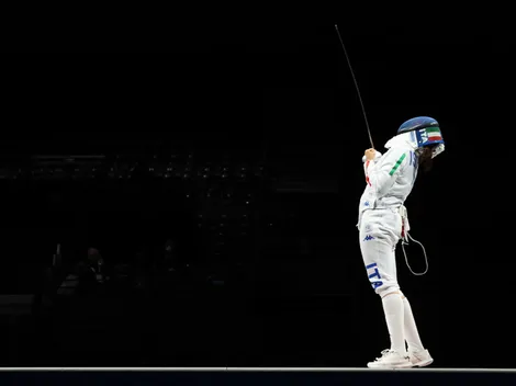 Why do fencers have a cable attached at the Paris 2024 Olympic Games?