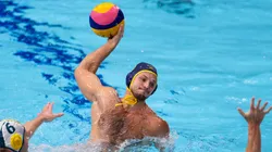 Alexey Shmider of Team Kazakhstan attacks under pressure from Lachlan Edwards (L) and Blake Edwards of Team Australia during the Men's Preliminary Round Group B match between Australia and Kazakhstan on day ten of the Tokyo 2020 Olympic Games.