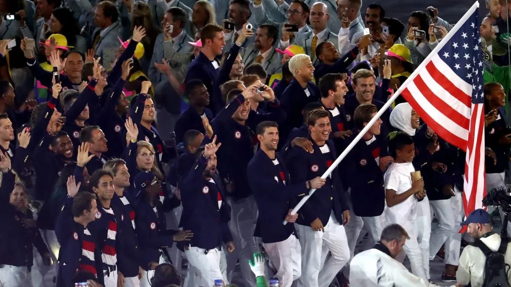 Flag bearer Michael Phelps of the United States and Ibtihaj Muhammad lead the U.S. Olympic Team during the Opening Ceremony of the Rio 2016 Olympic Games at Maracana Stadium on August 5, 2016 in Rio de Janeiro, Brazil. (Photo by Buda Mendes/Getty Images)