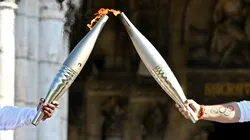 Claudia Tagbo, French-Ivorian actress and comedian and Pascal Touitou carry the Olympic Torch at Basilique du Sacre-Coeur de Montmartre during the second day of the Paris 2024 Olympic Torch Relay on July 15, 2024 in Paris, France.