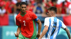 Achraf Hakimi #2 of Team Morocco is challenged by Kevin Zenon #7 of Team Argentina during the Men's group B match between Argentina and Morocco during the Olympic Games Paris 2024 at Stade Geoffroy-Guichard on July 24, 2024 in Saint-Etienne, France.