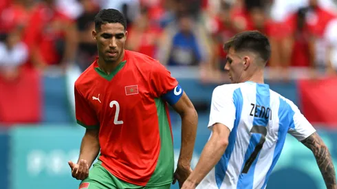 Achraf Hakimi #2 of Team Morocco is challenged by Kevin Zenon #7 of Team Argentina during the Men's group B match between Argentina and Morocco during the Olympic Games Paris 2024 at Stade Geoffroy-Guichard on July 24, 2024 in Saint-Etienne, France.