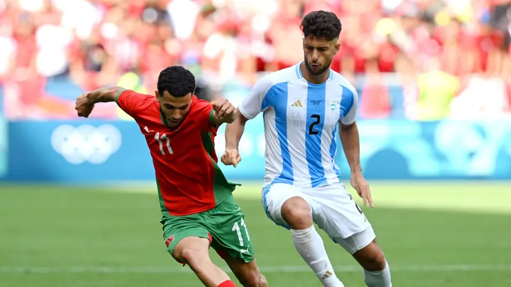 Zakaria el Ouahdi #11 of Team Morocco is challenged by Marco di Cesare #2 of Team Argentina during the Men's group B match between Argentina and Morocco during the Olympic Games Paris 2024 at Stade Geoffroy-Guichard on July 24, 2024 in Saint-Etienne, France.