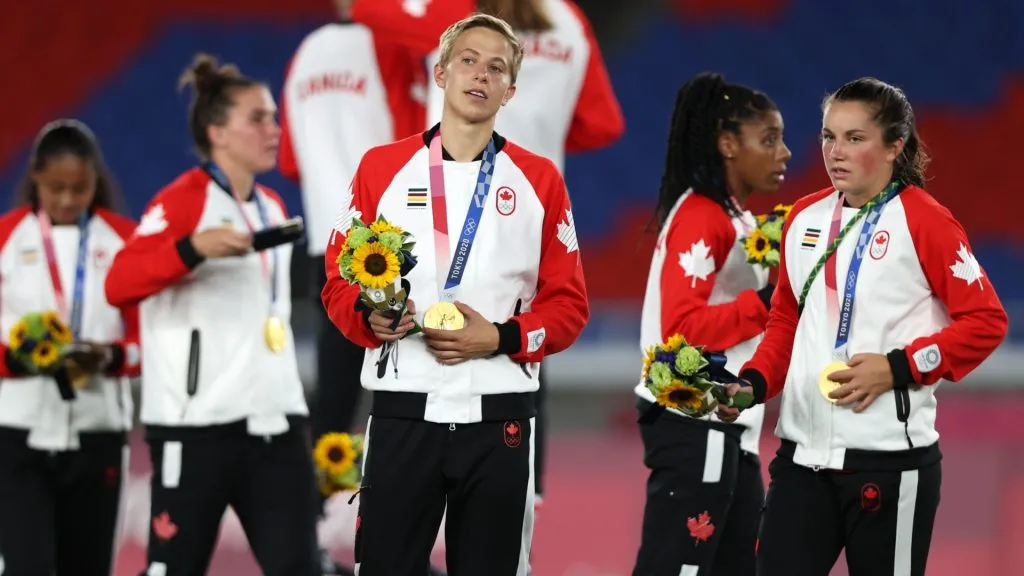 Gold medalist Quinn #5 of Team Canada reacts with their gold medal after becoming the first openly transgender athlete to win Olympic gold during the Gold Medal Match Womenās Football match between Canada and Sweden at International Stadium Yokohama on August 06, 2021 in Yokohama, Kanagawa, Japan. (Photo by Naomi Baker/Getty Images)