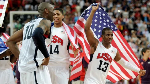 Team mates Kobe Bryant #10 of the United States, Anthony Davis #14 of the United States, and Chris Paul #13 of the United States celebrate winning the Men's Basketball gold medal game between the United States and Spain