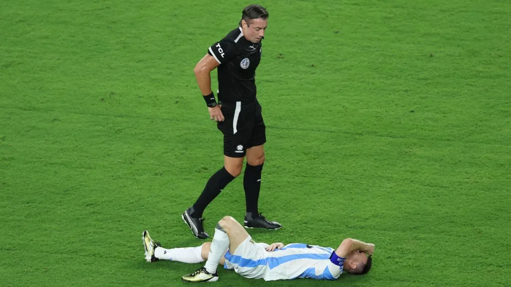 Lionel Messi of Argentina lies on the grass with an injury during the CONMEBOL Copa America 2024 Final match between Argentina and Colombia. Megan Briggs/Getty Images