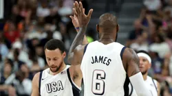 Stephen Curry #4 and LeBron James #6 of the United States high-five in the second half of their exhibition game against Canada ahead of the Paris Olympic Games at T-Mobile Arena.