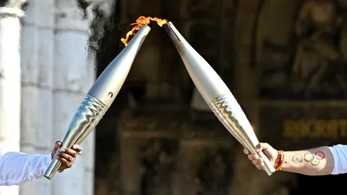 Claudia Tagbo, French-Ivorian actress and comedian and Pascal Touitou carry the Olympic Torch at Basilique du Sacre-Coeur de Montmartre during the second day of the Paris 2024 Olympic Torch Relay on July 15, 2024 in Paris, France.