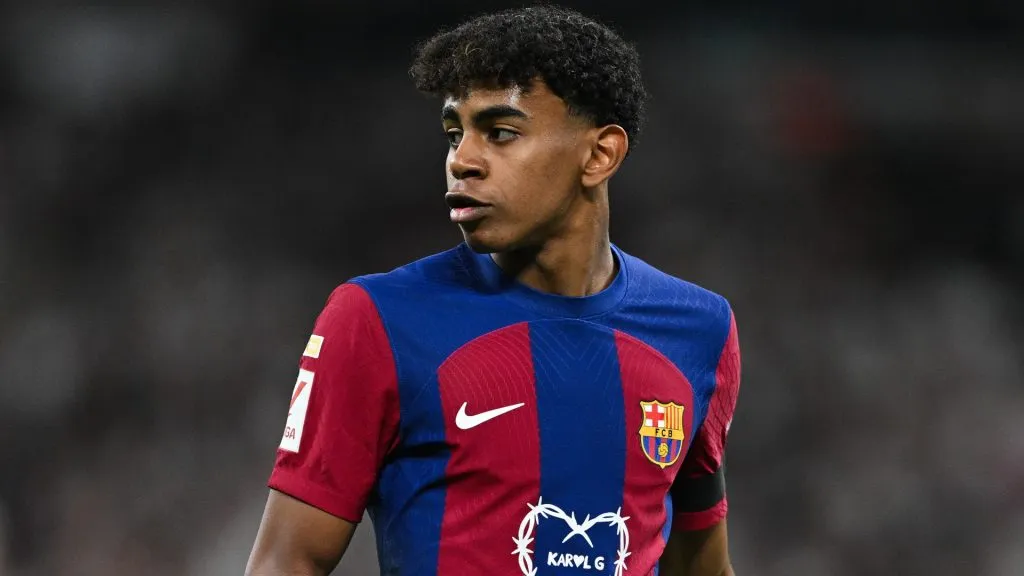 Lamine Yamal of FC Barcelona looks on whilst wearing a Karol G limited edition match shirt during the LaLiga EA Sports match between Real Madrid CF and FC Barcelona at Estadio Santiago Bernabeu on April 21, 2024 in Madrid, Spain. (Photo by David Ramos/Getty Images)