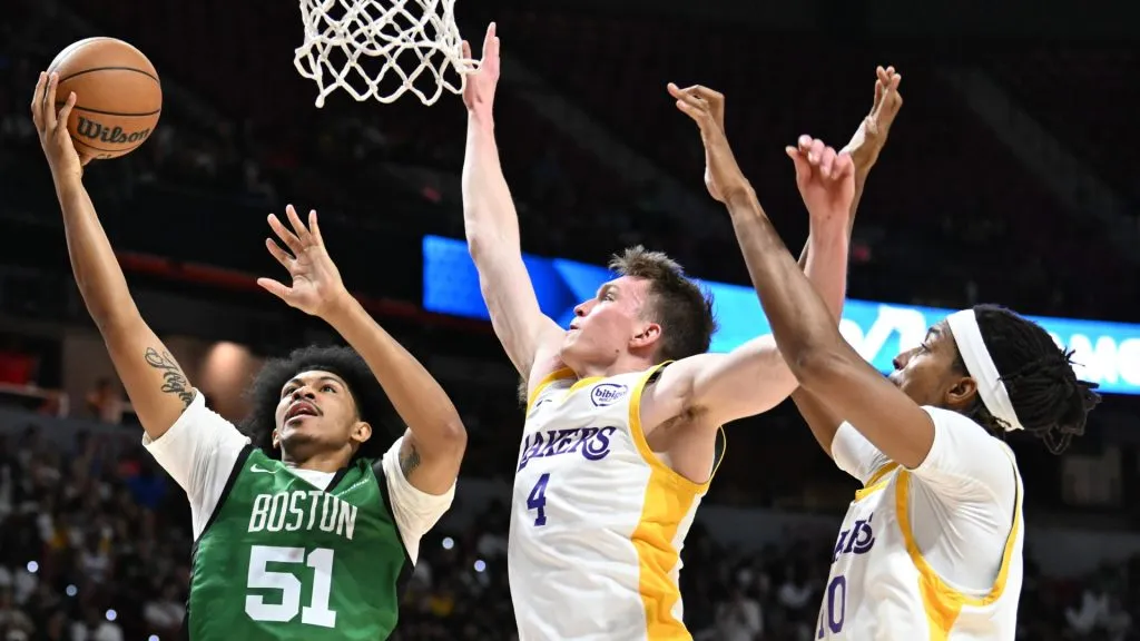 Ron Harper Jr. #51 of the Boston Celtics drives to the basket against Dalton Knecht #4 and Moses Brown #40 of the Los Angeles Lakers in the first half of a 2024 NBA Summer League game at the Thomas & Mack Center on July 15, 2024 in Las Vegas, Nevada. The Celtics defeated the Lakers 88-74. Photo by Candice Ward/Getty Images