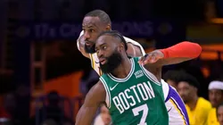 LeBron James #23 of the Los Angeles Lakers collides with Jaylen Brown #7 of the Boston Celtics in the first half at Crypto.com Arena on December 25, 2023 in Los Angeles, California.