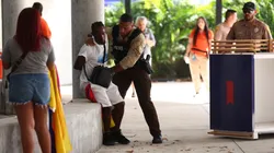 A fan of Colombia is detained by a police officer outside the stadium prior the CONMEBOL Copa America 2024 Final match between Argentina and Colombia at Hard Rock Stadium