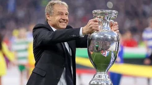 Jurgen Klinsmann, German former professional player and manager, holds the UEFA Euro 2024 Henri Delaunay Trophy prior to kick-off ahead of the UEFA EURO 2024