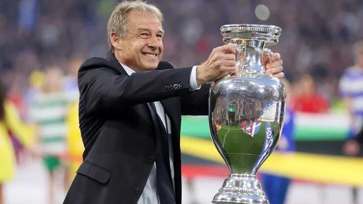 Jurgen Klinsmann, German former professional player and manager, holds the UEFA Euro 2024 Henri Delaunay Trophy prior to kick-off ahead of the UEFA EURO 2024