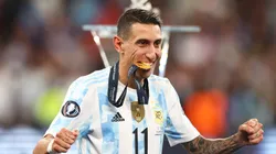 Angel Di Maria of Argentina bites on their winners medal as they walk to the podium after the final whistle of the 2022 Finalissima match between Italy and Argentina at Wembley Stadium on June 01, 2022 in London, England.