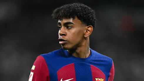Lamine Yamal of FC Barcelona looks on whilst wearing a Karol G limited edition match shirt during the LaLiga EA Sports match between Real Madrid CF and FC Barcelona at Estadio Santiago Bernabeu on April 21, 2024 in Madrid, Spain.