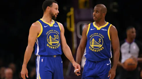 Stephen Curry #30 and Chris Paul #3 of the Golden State Warriors talk after a stop in play against the Los Angeles Lakers during the first half in a preseason game.