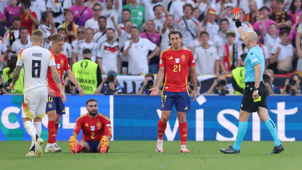 Referee Anthony Taylor shows a red card to Daniel Carvajal of Spain, following a second yellow card for a foul on Jamal Musiala of Germany during the UEFA EURO 2024 quarter-final match. Photo by Alex Livesey/Getty Images