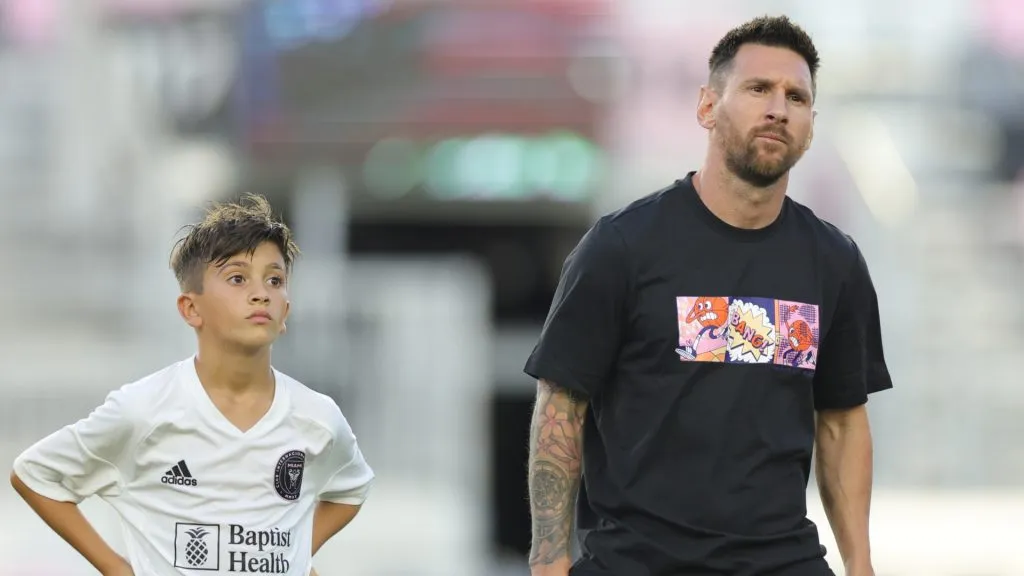 Lionel Messi stands alongside Thiago Messi during the Youth International Cup Opening Ceremony match at Chase Stadium on May 24, 2024 in Fort Lauderdale, Florida.