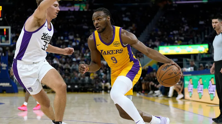 Bronny James Jr. #9 of the Los Angeles Lakers drives to the basket on Dane Goodwin #33 of the Sacramento Kings during the second half of a 2024 California Classic summer league game at Chase Center
