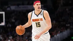 Nikola Jokic #15 of the Denver Nuggets dribbles against the Memphis Grizzlies at Ball Arena.
