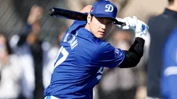 Shohei Ohtani #17 of the Los Angeles Dodgers swings the bat during workouts at Camelback Ranch.