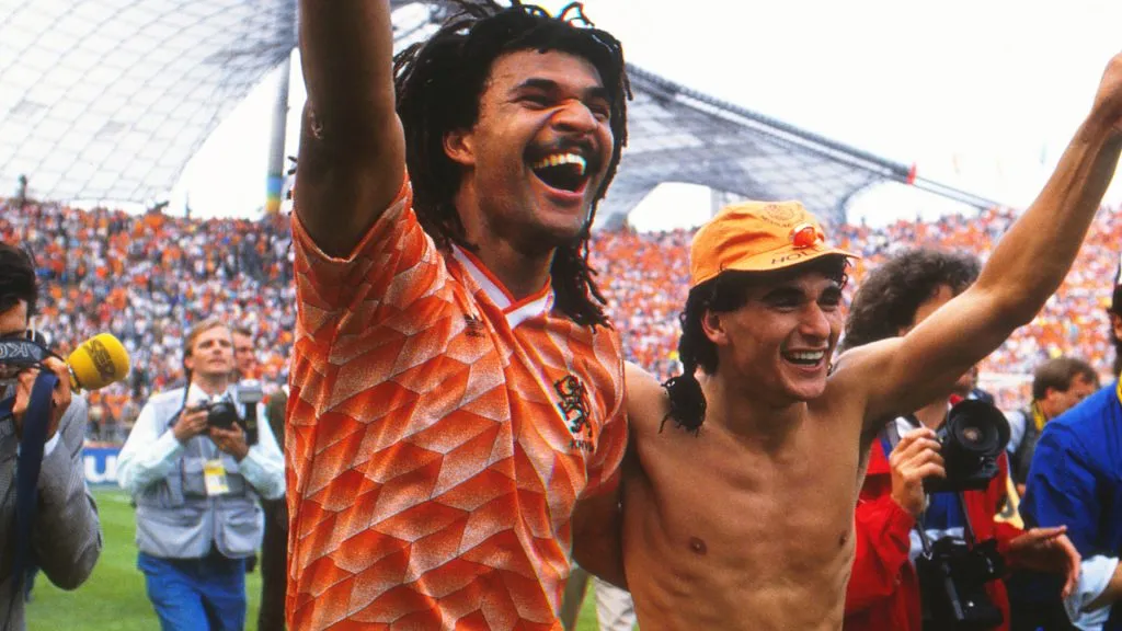 Holland captain Ruud Gullit (left) celebrates with teammate Gerald Vanenburg after victory at the Olympiastadion, Munich. IMAGO / Colorsport