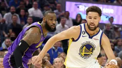 Klay Thompson #11 of the Golden State Warriors dribbles past LeBron James #6 of the Los Angeles Lakers at Chase Center on October 18, 2022 in San Francisco, California.