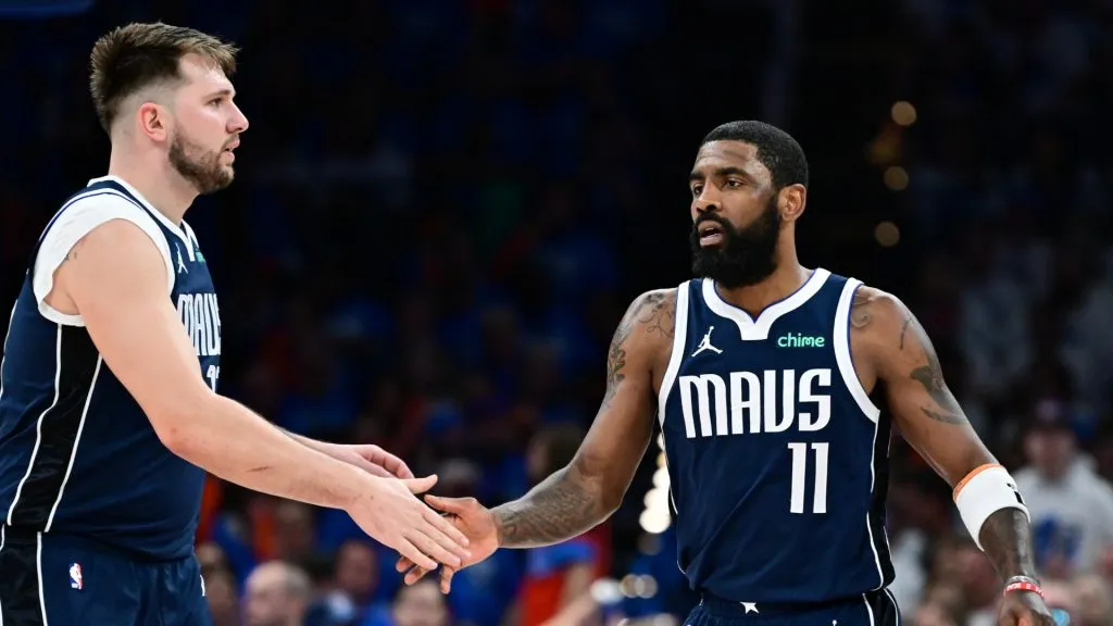 Luka Doncic #77 high fives Kyrie Irving #11 of the Dallas Mavericks during the third quarter against the Oklahoma City Thunder. Joshua Gateley/Getty Images