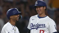 Shohei Ohtani #17 and Mookie Betts #50 of the Los Angeles Dodgers reacts to their run from a Teoscar Hernández #37 three run home run, to take a 5-3 lead over the Baltimore Orioles, during the third inning at Dodger Stadium.