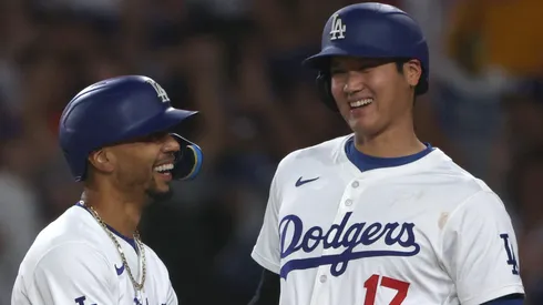 Shohei Ohtani #17 and Mookie Betts #50 of the Los Angeles Dodgers reacts to their run from a Teoscar Hernández #37 three run home run, to take a 5-3 lead over the Baltimore Orioles, during the third inning at Dodger Stadium.