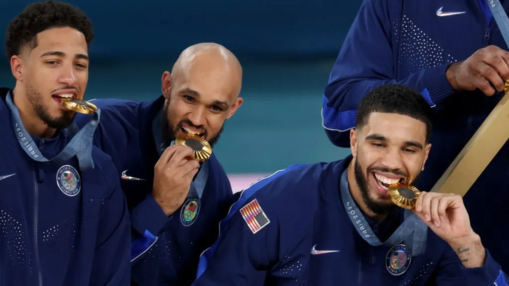 Gold medalists Tyrese Haliburton, Derrick White, and Jayson Tatum of Team United States pose with their medals. Jamie Squire/Getty Images