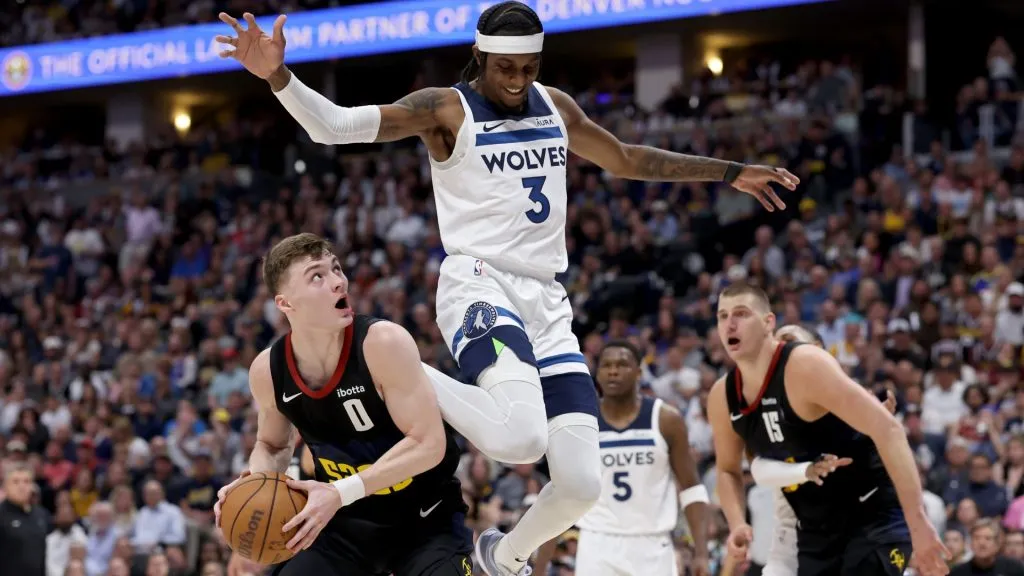 Christian Braun #0 of the Denver Nuggets drives to the basket against Jaden McDaniels #3 of the Minnesota Timberwolves during the second quarter in Game Five of the Western Conference Second Round Playoffs at Ball Arena. (Photo by Matthew Stockman/Getty Images)