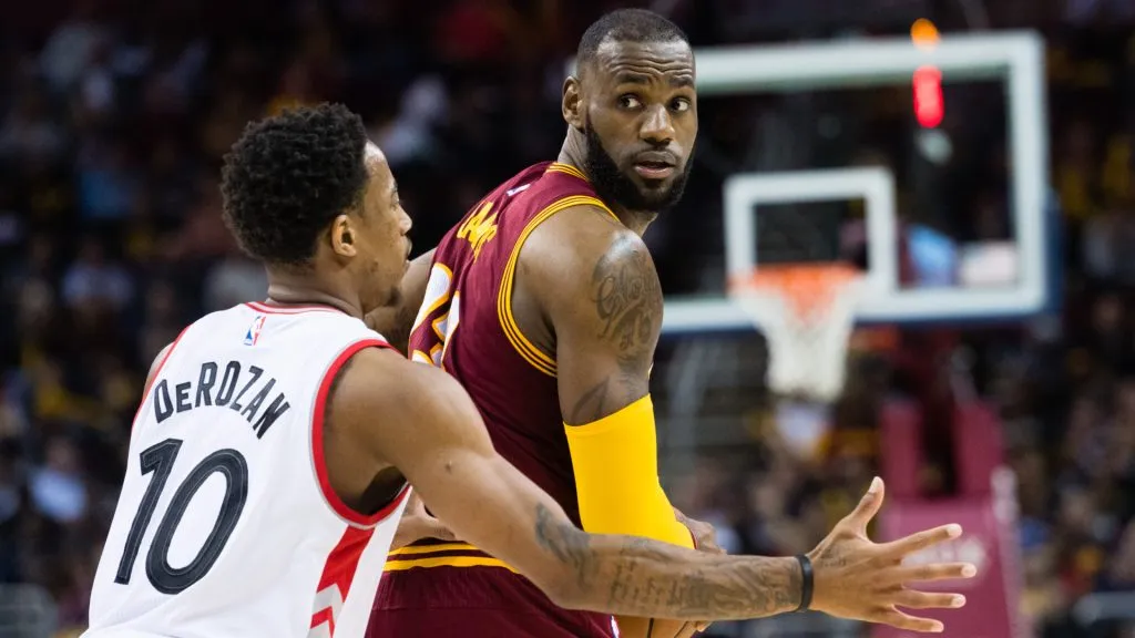 LeBron James #23 of the Cleveland Cavaliers looks for a pass while under pressure from DeMar DeRozan #10 of the Toronto Raptors. Jason Miller/Getty Images