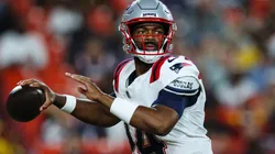 Jacoby Brissett #14 of the New England Patriots looks to pass against the Washington Commanders in the first quarter of a preseason game at Commanders Field on August 25, 2024 in Landover, Maryland.