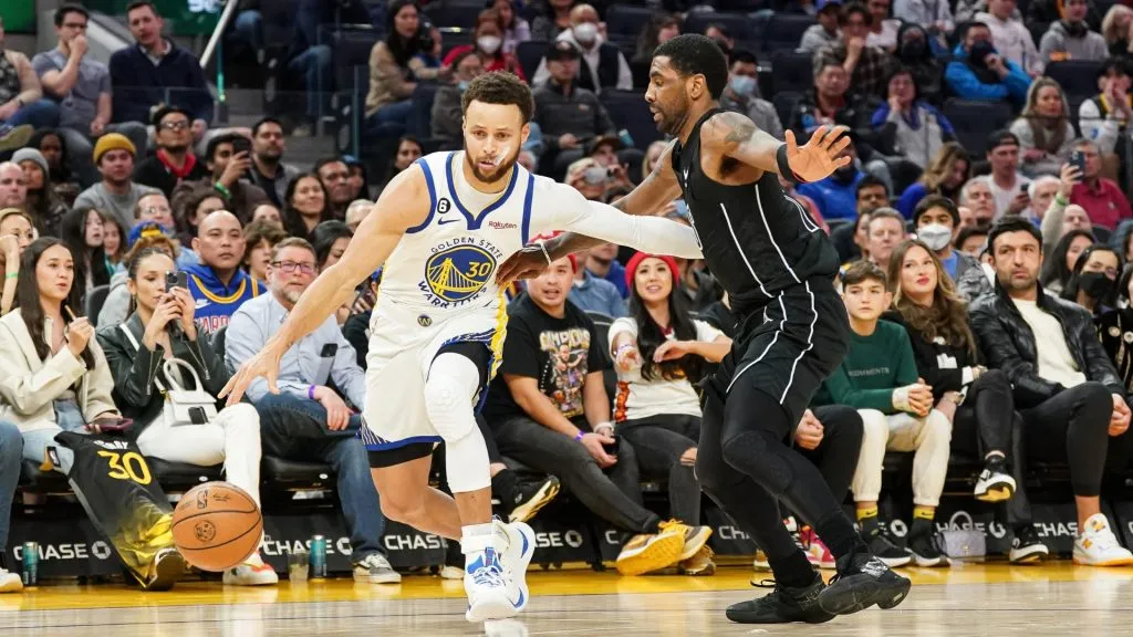 Stephen Curry #30 of the Golden State Warriors dribbles the ball in the fourth quarter against Kyrie Irving #11 of the Brooklyn Nets at Chase Center on January 22, 2023 in San Francisco, California. (Photo by Kavin Mistry/Getty Images)